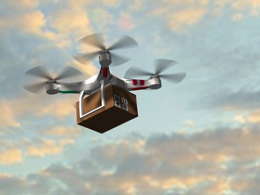 drone quadrocopter UAV with package fly in the sky